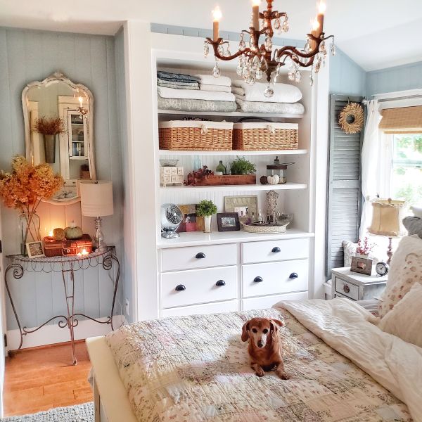 Built in, chandelier, patchwork quilt and dachshund on bed