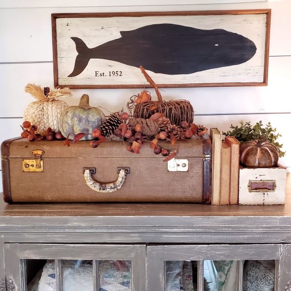 Fall decor vignette with suitcase and pumpkins