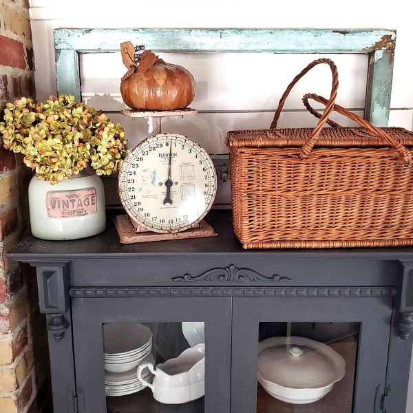 Fall decor with vintage scale, picnic basket, glass window