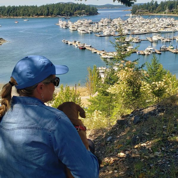 Kim and Lucy dog overlooking boats and Roche Harbor, WA