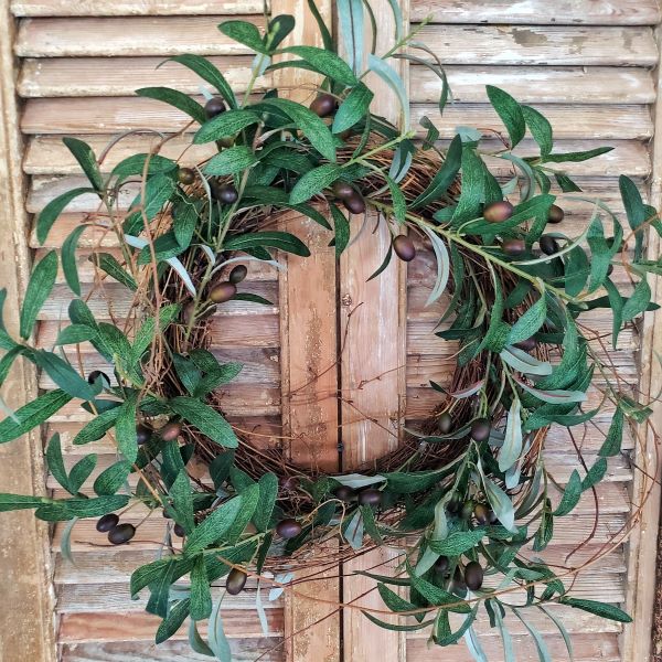 faux olive tree wreath hanging on shutters