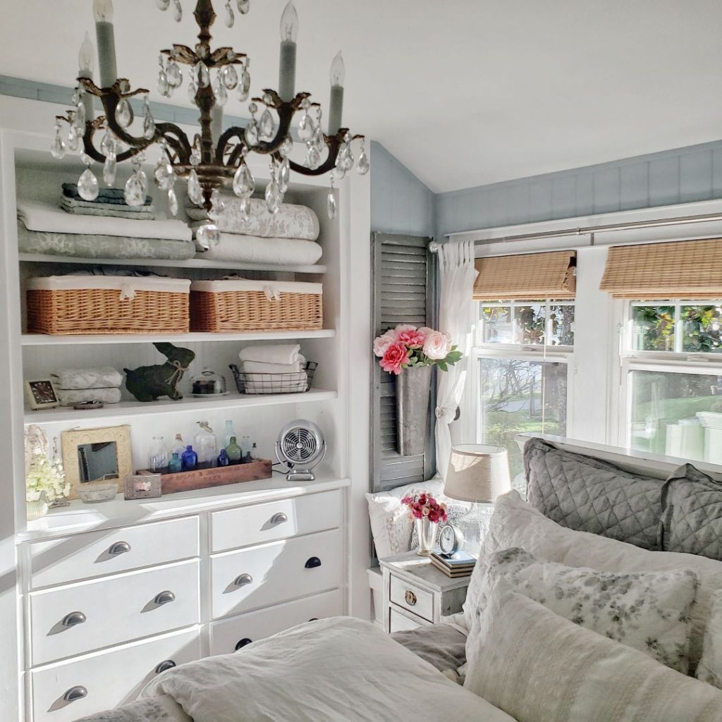 Cottage bedroom with  flowers and chandelier create a romantic feel for spring.