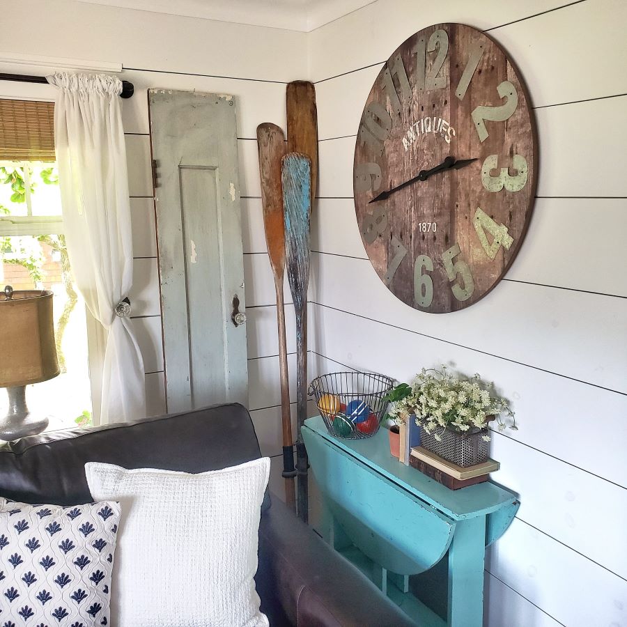 Vintage oars and summer decor in corner of living room