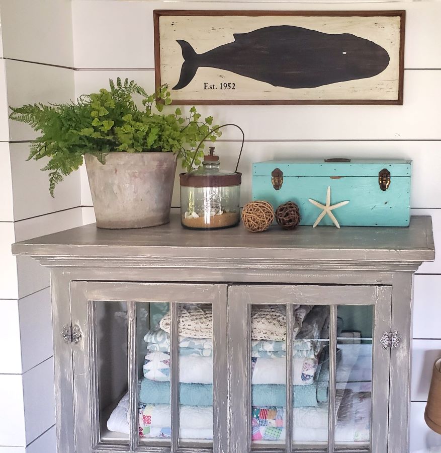 whale picture and other summer decor in cottage living room