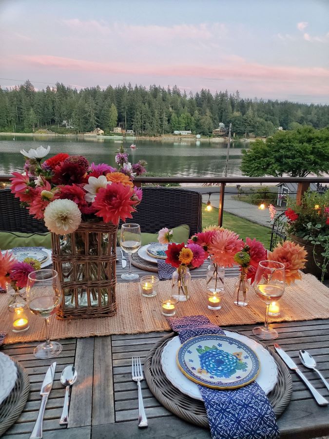 Fresh cut flowers and candles on table, overlooking the waterview