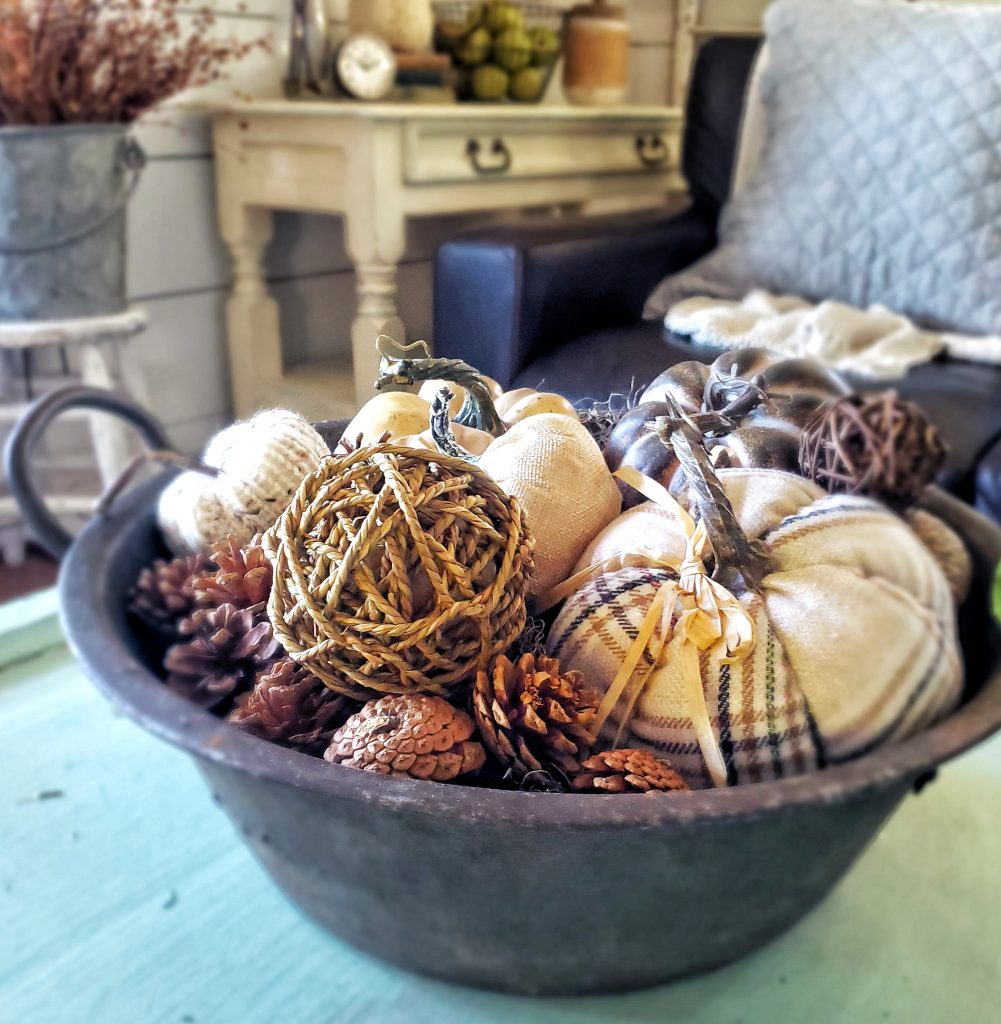 Faux pumpkins in a metal container