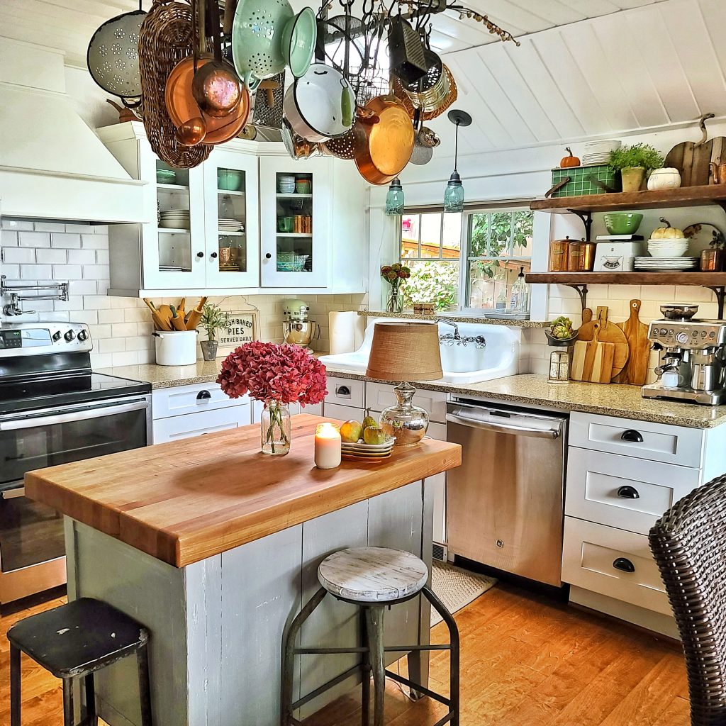cozy fall cottage kitchen with island and pan rack