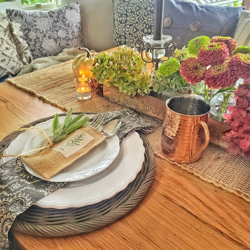 Fall tablescape with herbs and hydrangeas and a copper mug