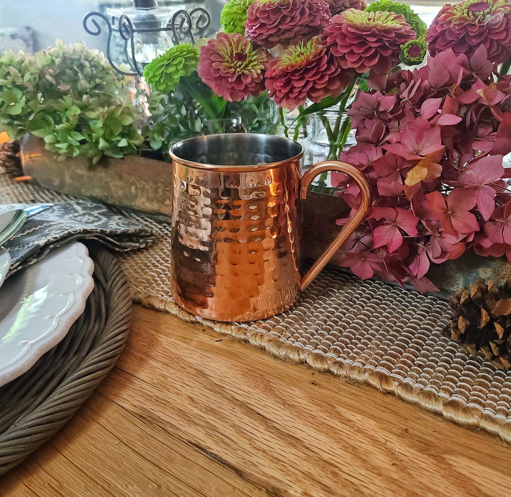 Dried hydrangeas, zinnias and a copper mug