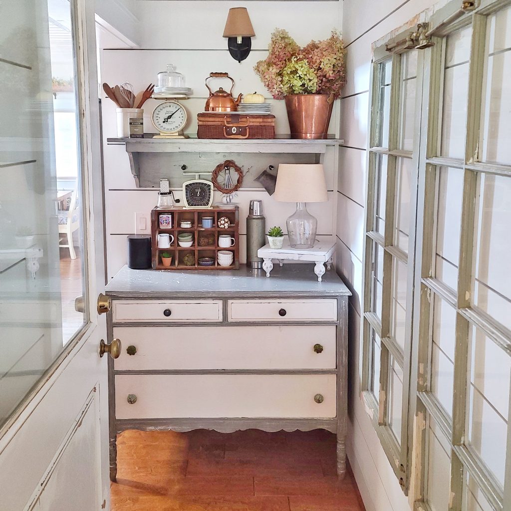 cozy fall dresser in kitchen hall with copper accessories