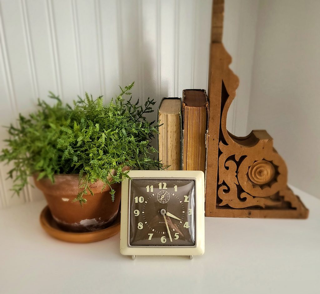 fall vignette with vintage clock, corbel and books