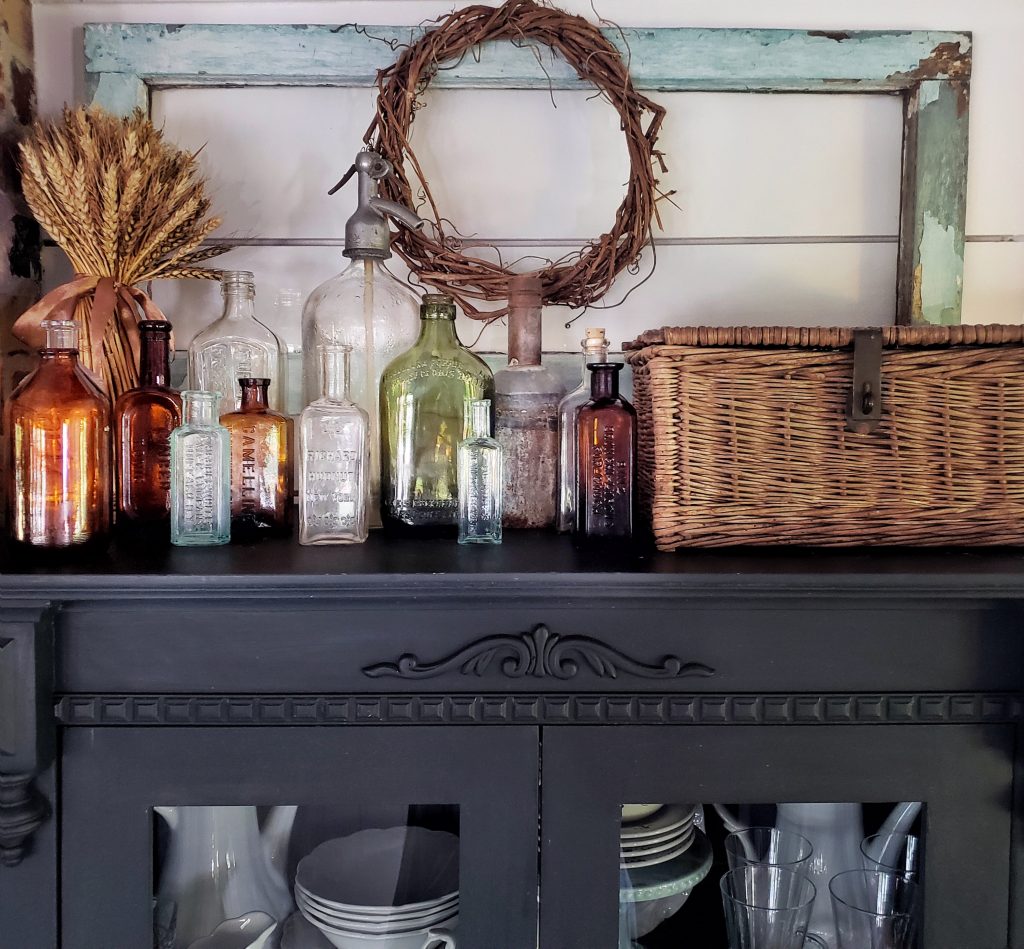 glass bottles and picnic basket and fall decor