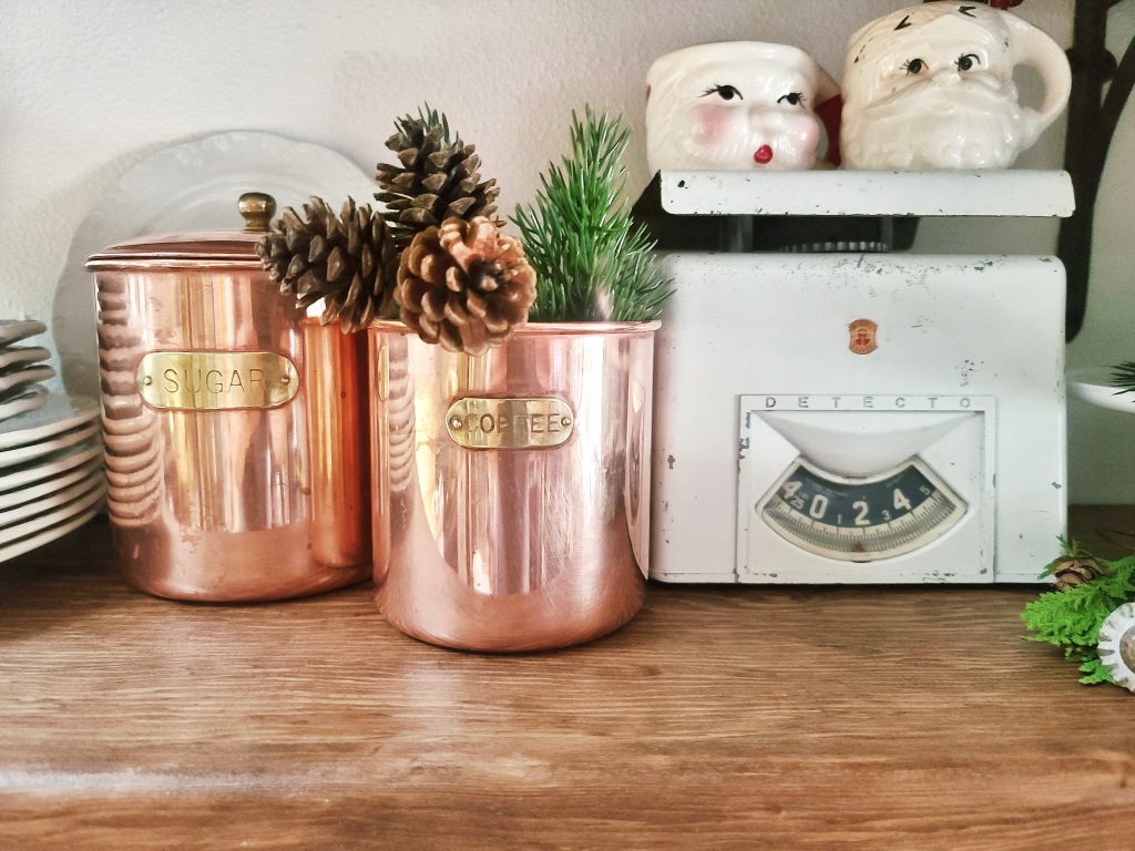 copper canisters and white vintage scale with Santa mugs