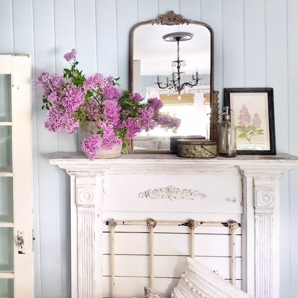 Faux Fireplace Mantel Surround with lilacs in container