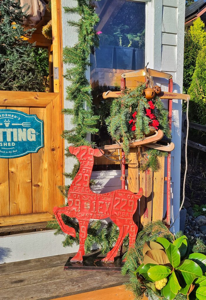 Christmas front porch with red metal reindeer