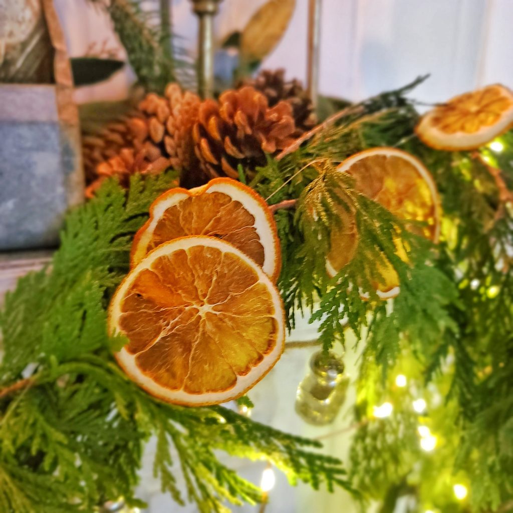 Cottage Christmas decor ideas: dried oranges ties to fresh greenery and pine cones