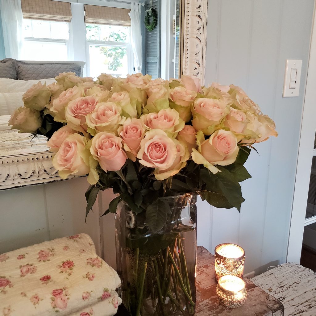 Pink roses and candlelight in bedroom
