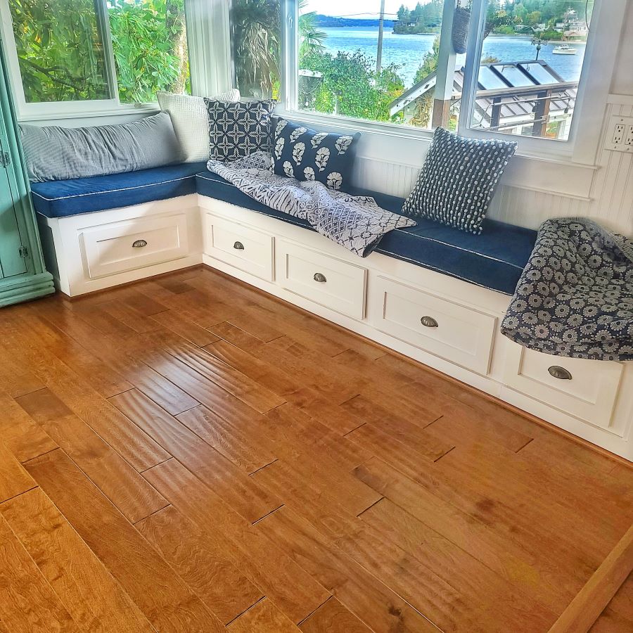 window seat with navy and white pillows and cushions and storage underneath
