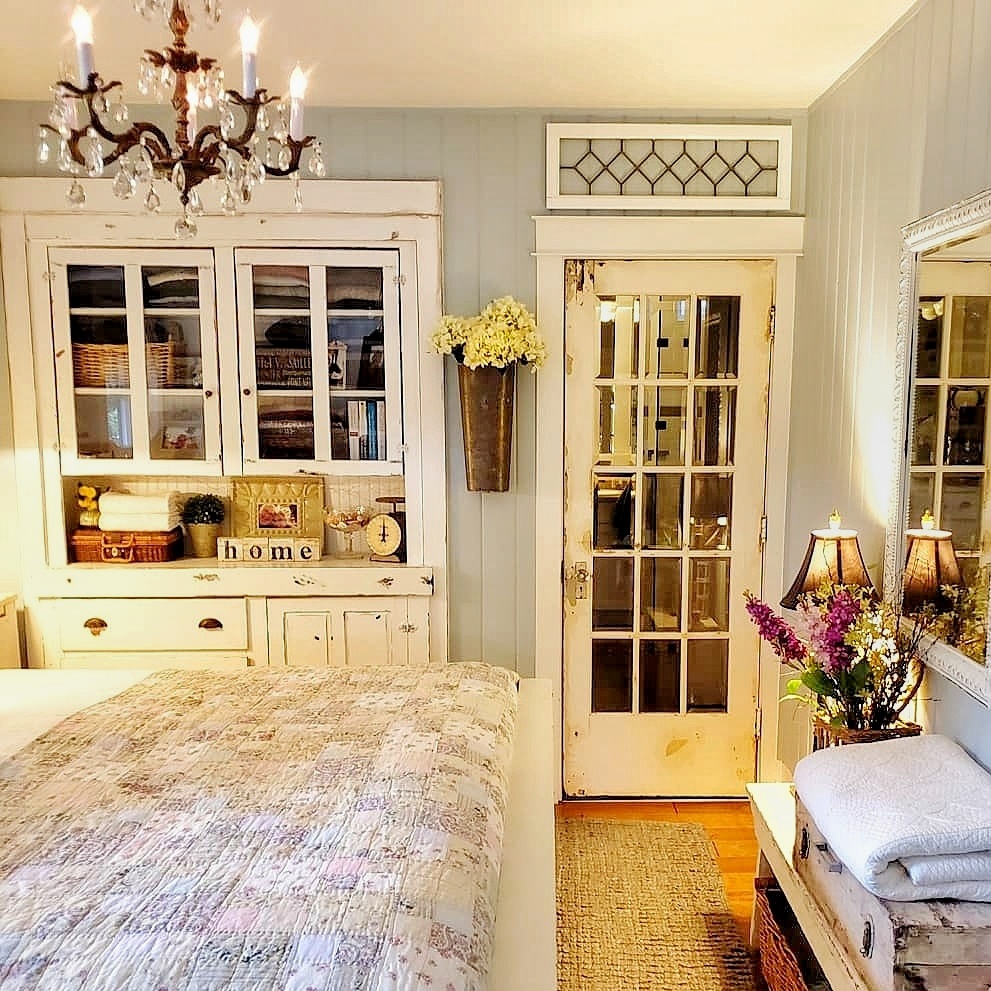 cottage bedroom with antique built in cabinet for storage