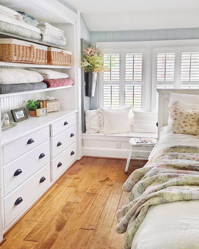 cottage bedroom with plantation shutters and built-in