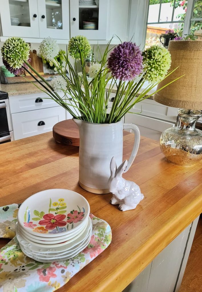 faux spring flowers in pitcher
