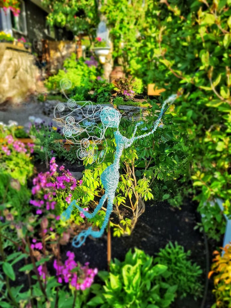 June cottage garden with fairy sprite