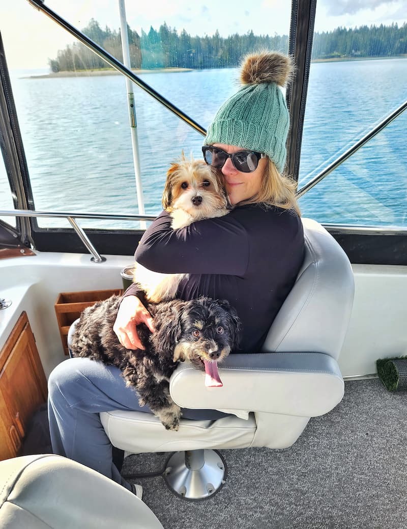 on the boat in winter with two dogs on my lap