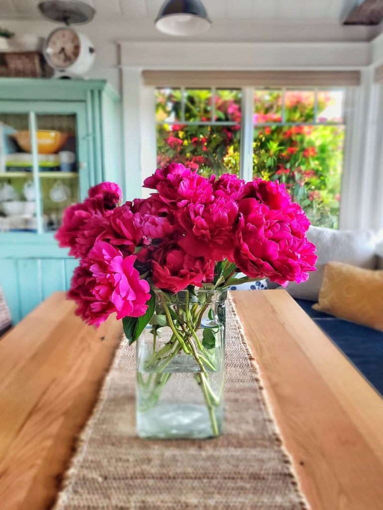 vase of peonies on farmhouse table