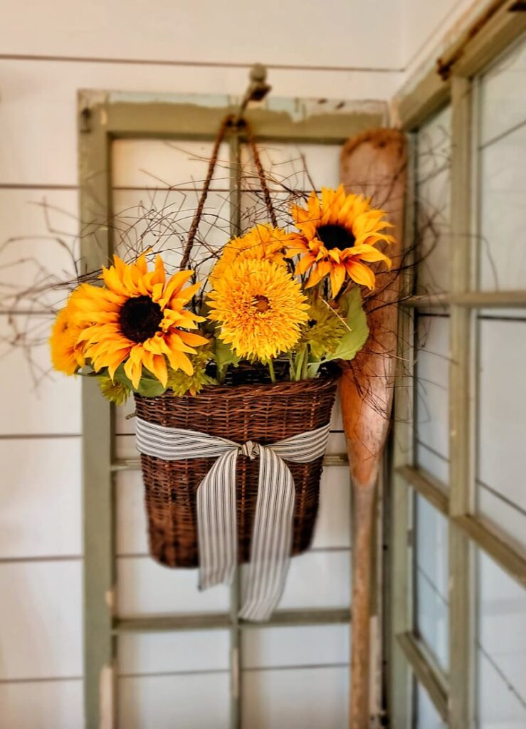 faux sunflowers hanging in basket
