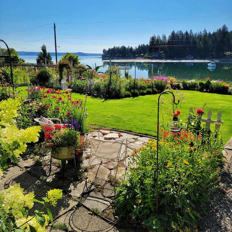 Summer cottage garden seating area overlooking the Puget Sound
