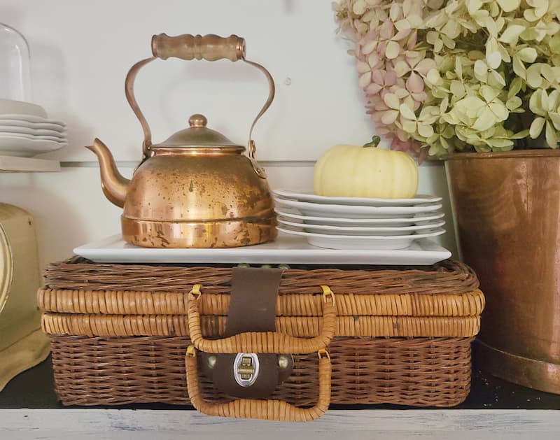wicker picnic basket with vintage copper kettle and ironstone