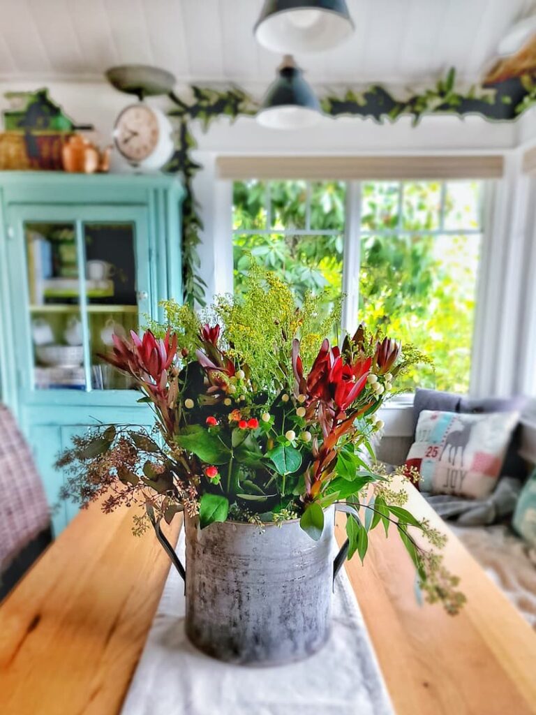 planning ahead for Christmas decor - holiday arrangement on kitchen table 