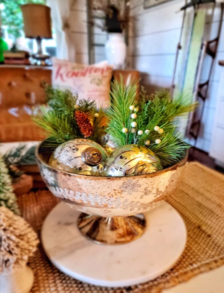 mercury glass bowl filled with ornaments and greens