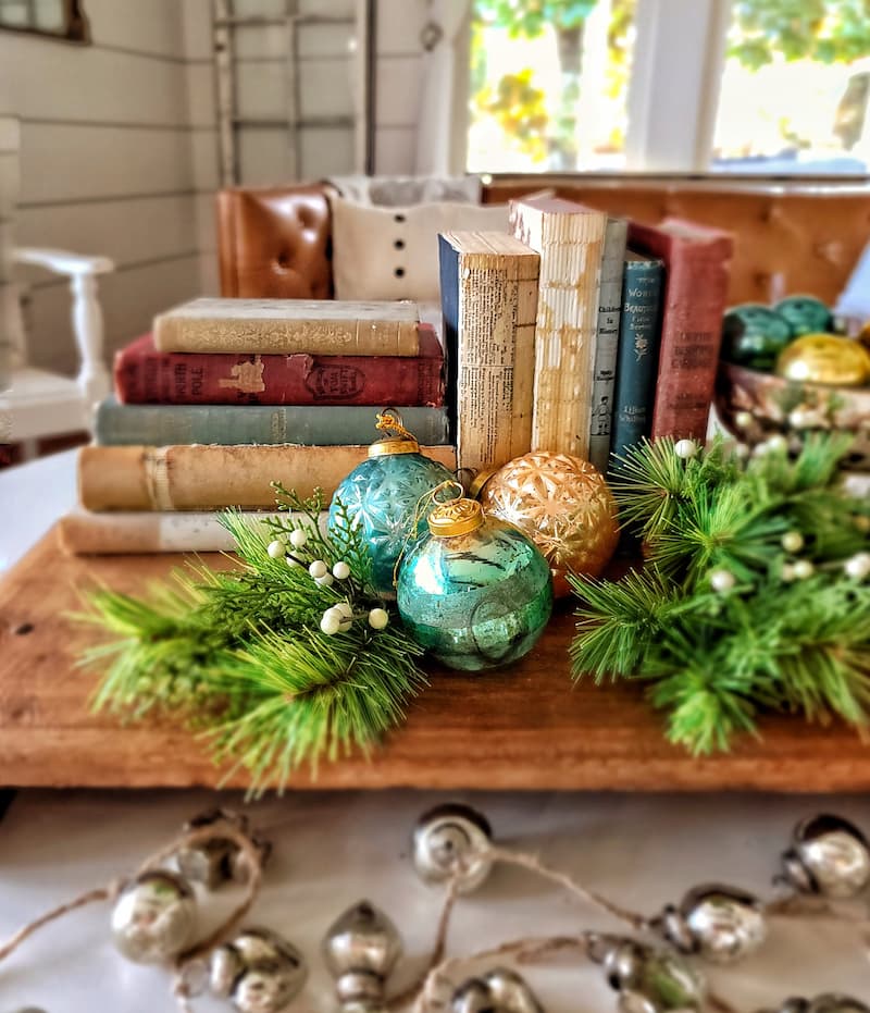 planning ahead for Christmas decor - vintage books and Christmas tree ball ornaments