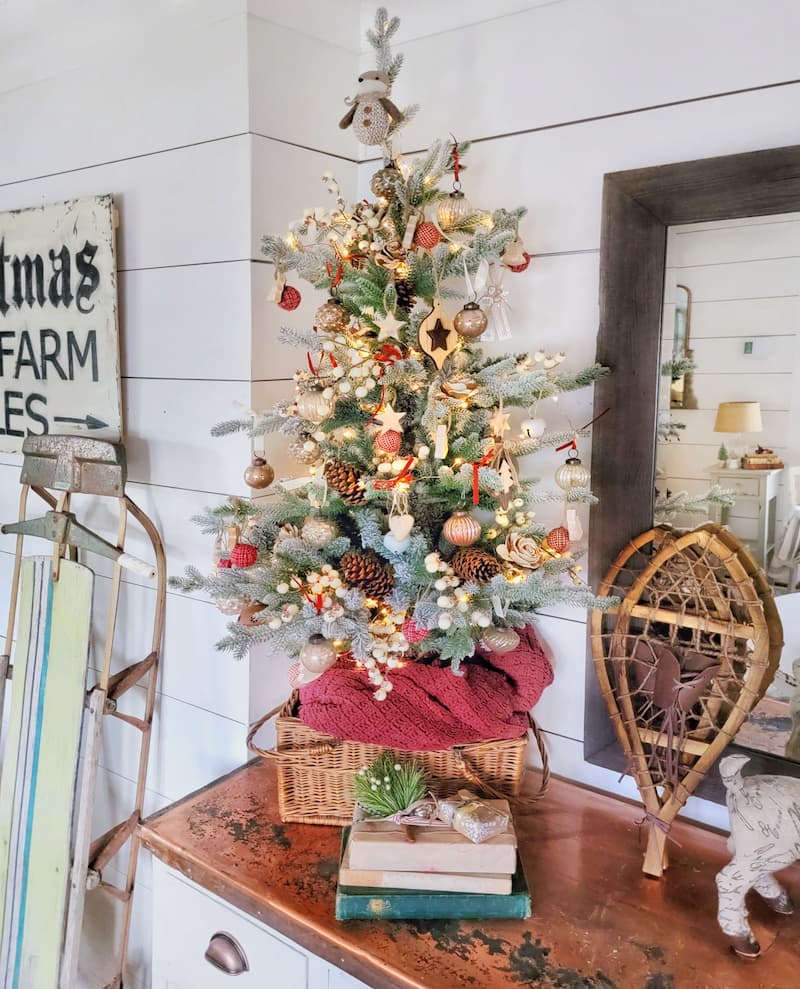 Christmas decor theme: mini Christmas tree decorated with rustic ornaments and mini snowshoes and sled