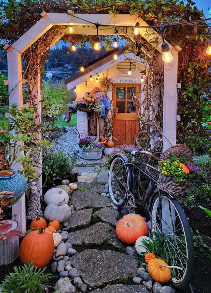 fall garden pathway with pumpkins and bike