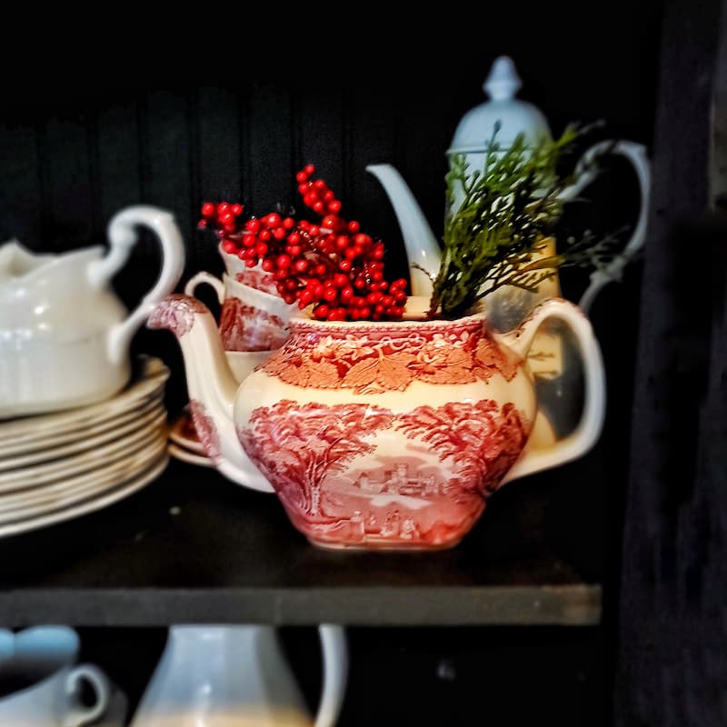 red and white transferware with berries and greenery