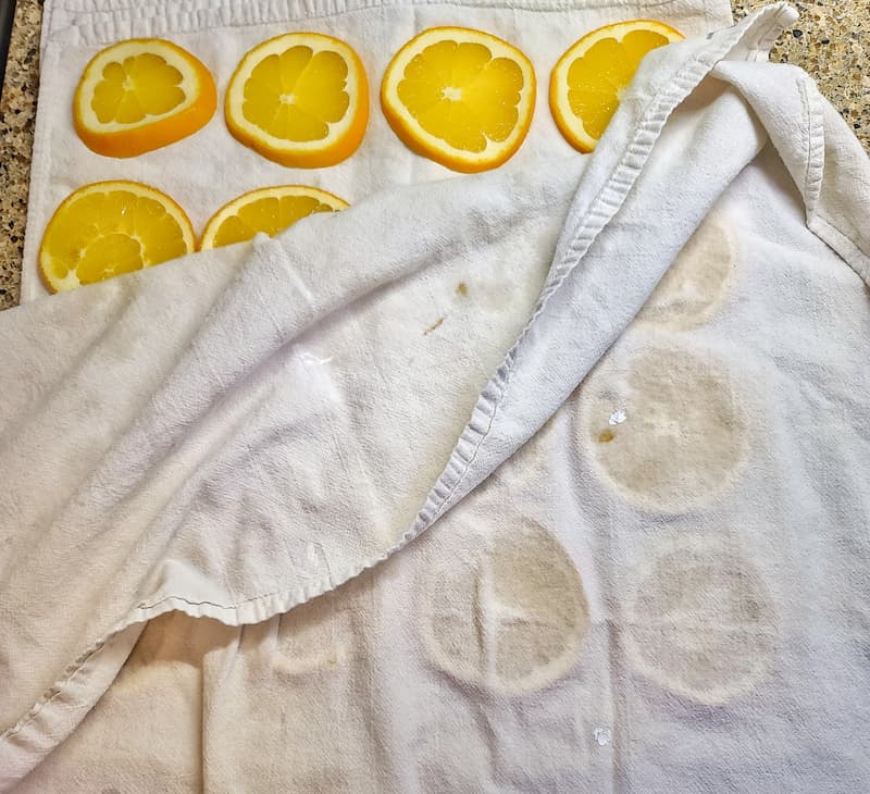 blotting excess water from oranges
