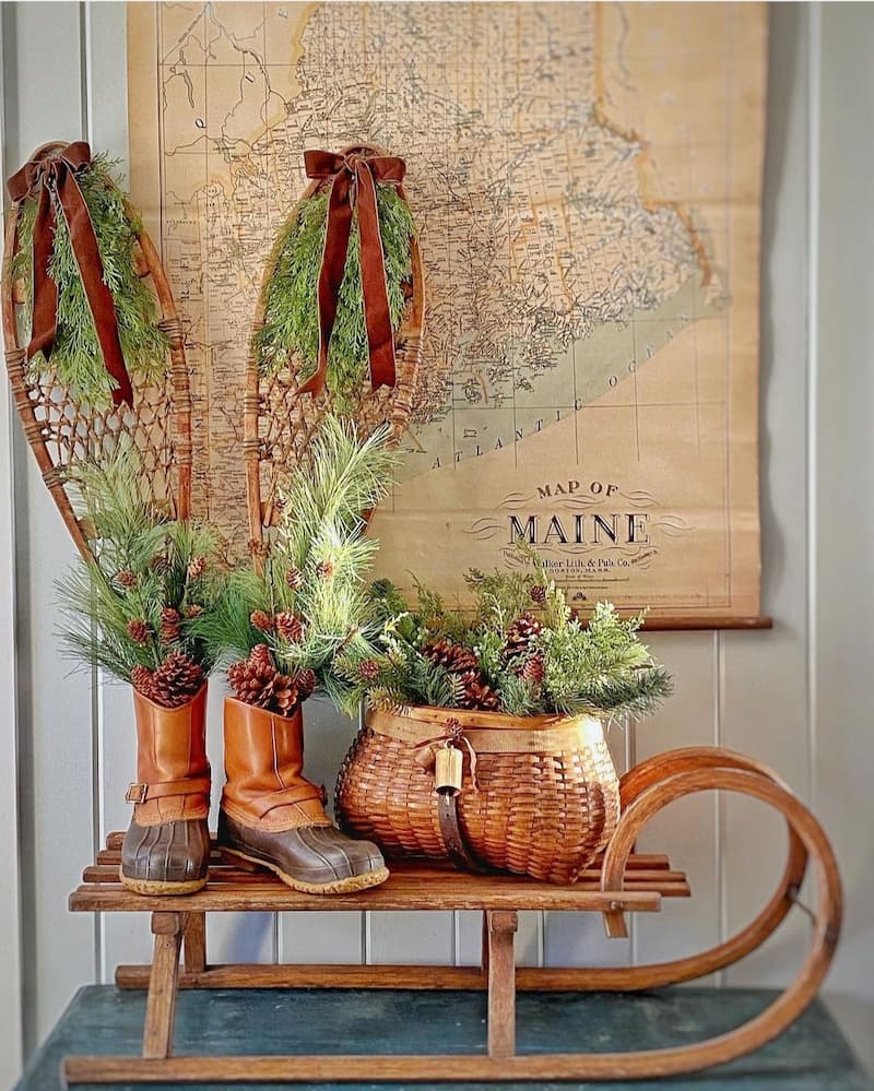 snowshoes and sled with basket full of greenery