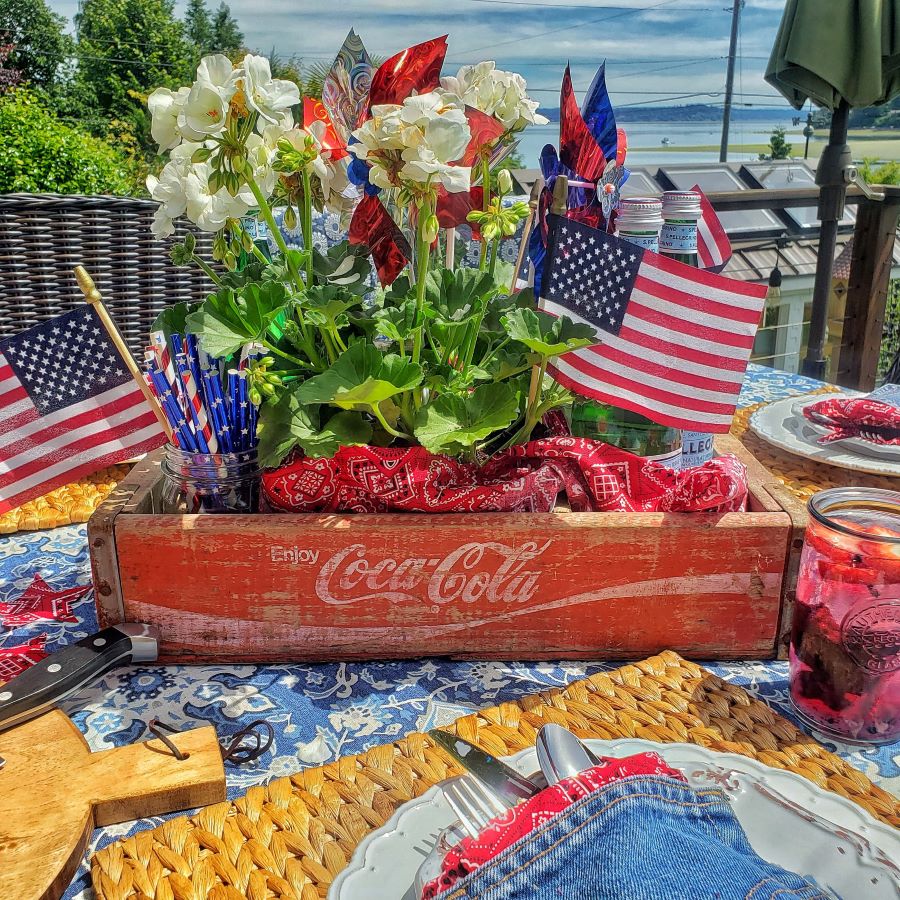 vintage coca cola crate with geraniums and patriotic decor