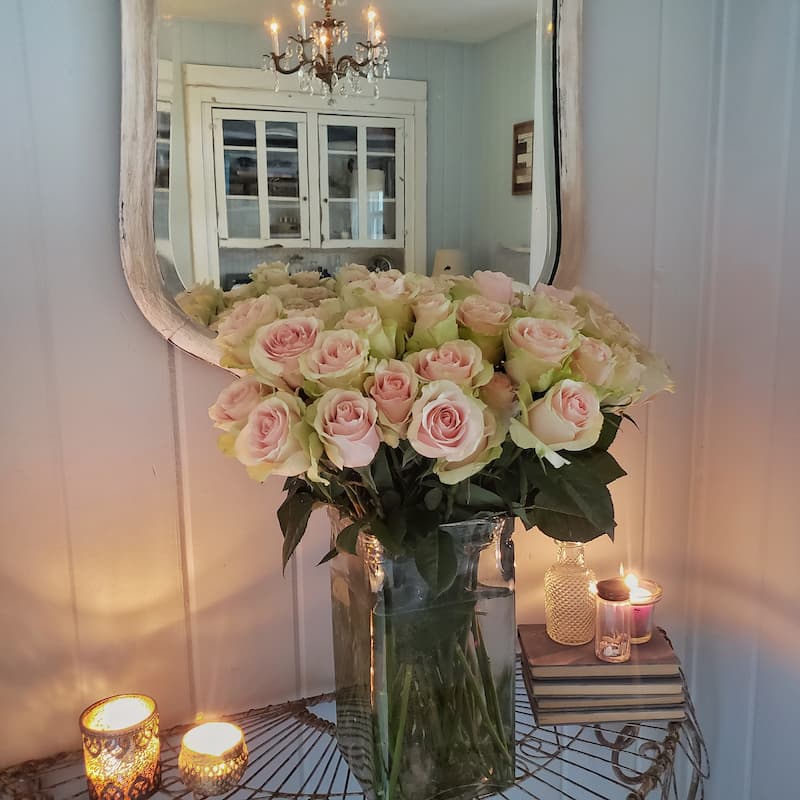 roses in vase with mirror
