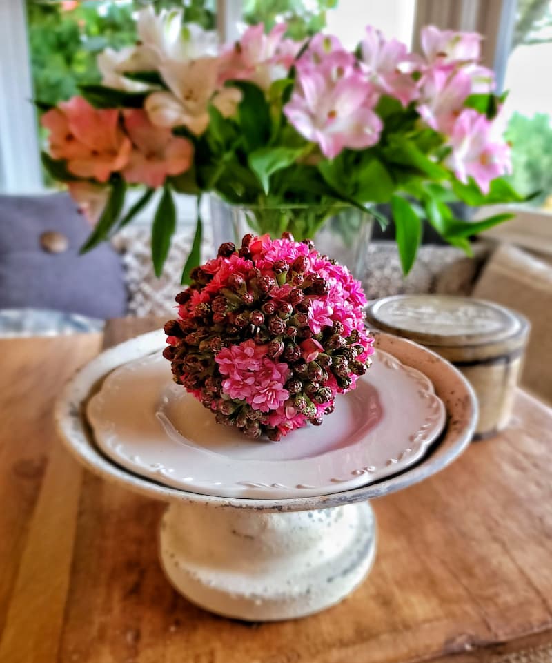 pink flower ball on pedestal