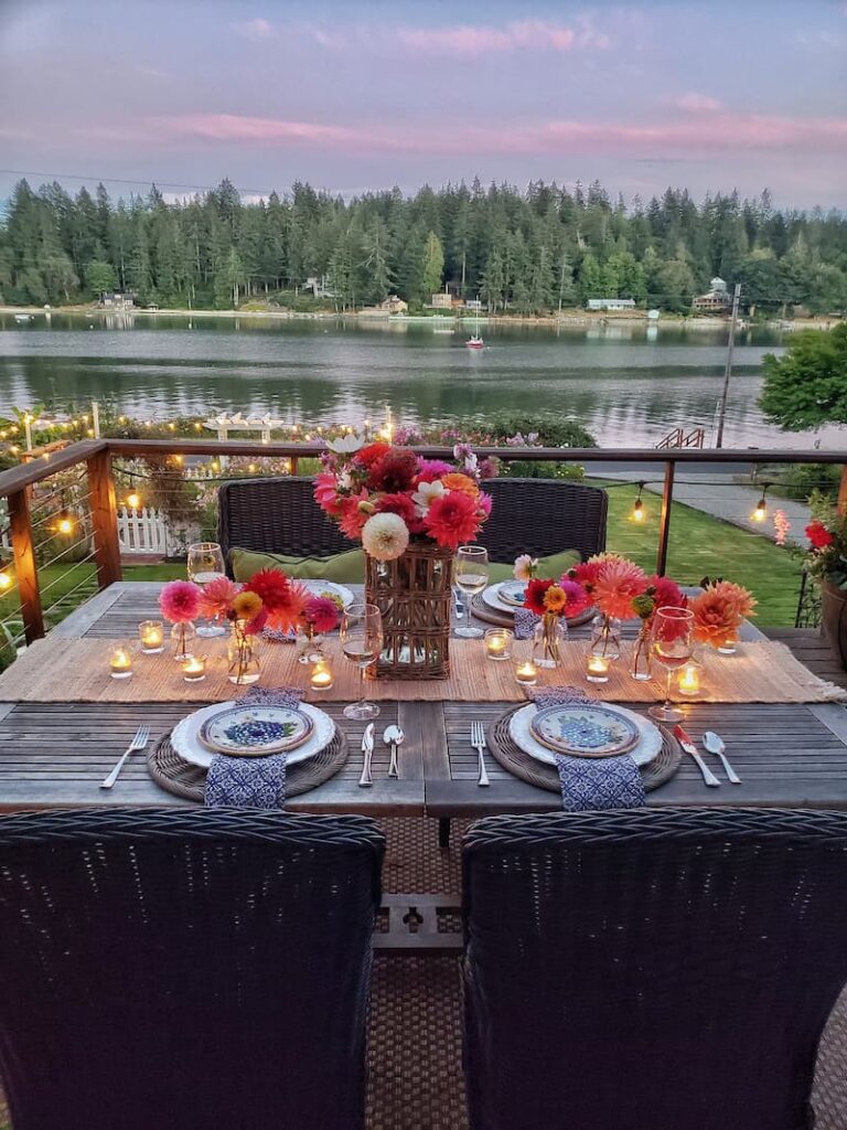 Summer tablescape ideas:  summer outdoor dining with dahlia centerpiece and overlooking the bay