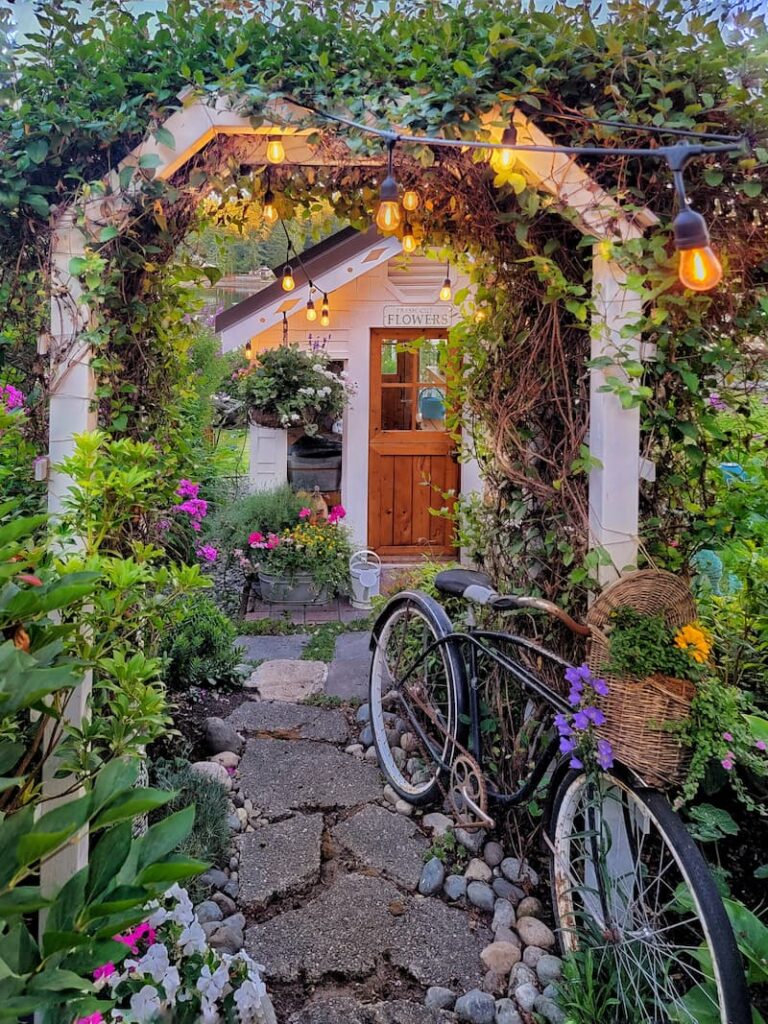 greenhouse pathway with vintage bike and flower baskets