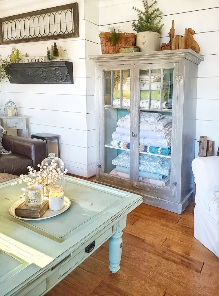 vintage cabinet in living room with winter decor