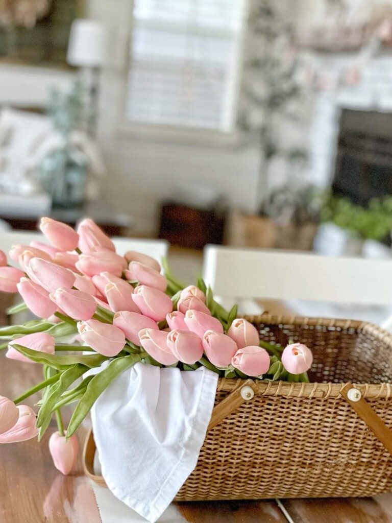 pink faux tulips in a basket decorated for spring
