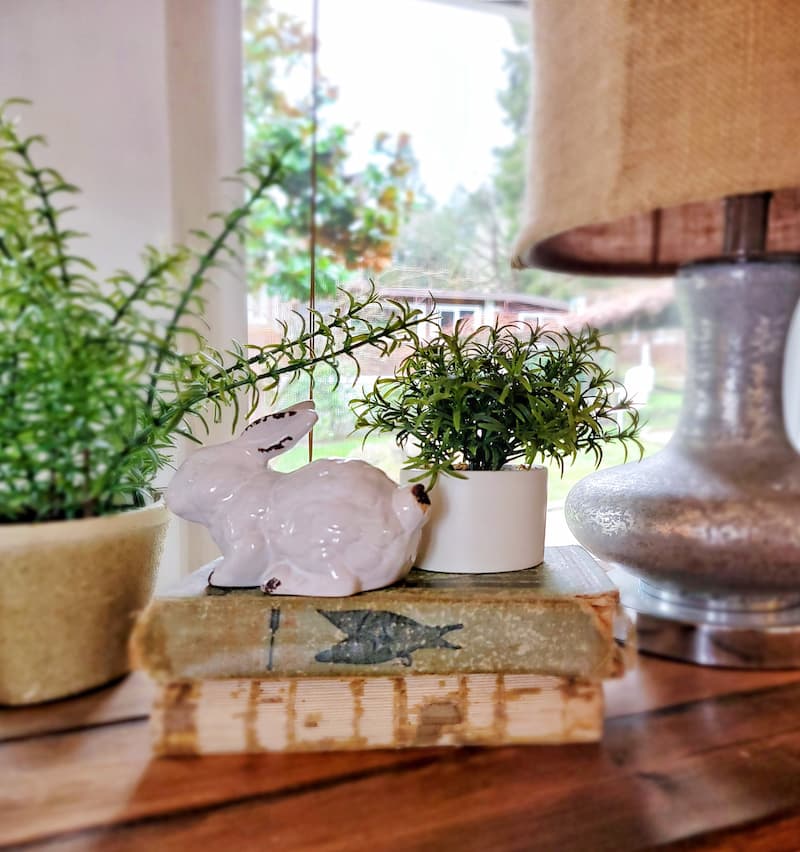 white ceramic bunny, faux plants and vintage books