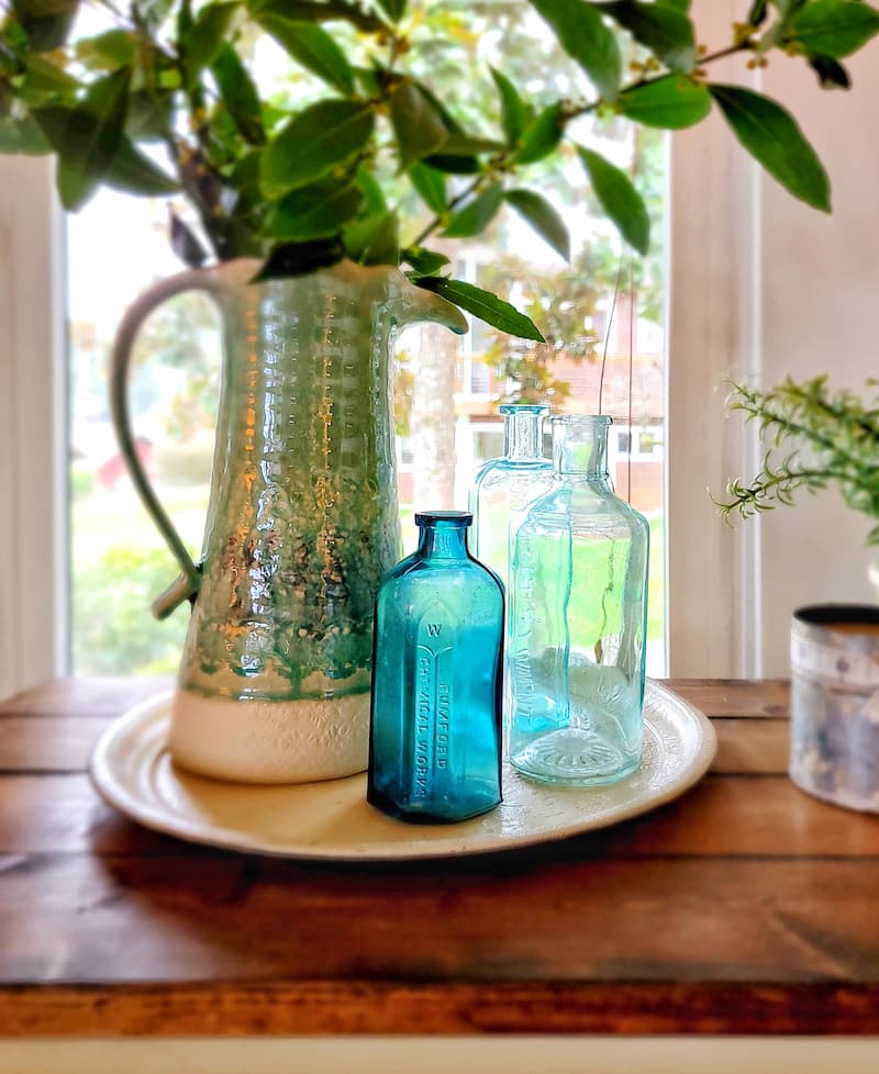 blue pitcher and glass botlles