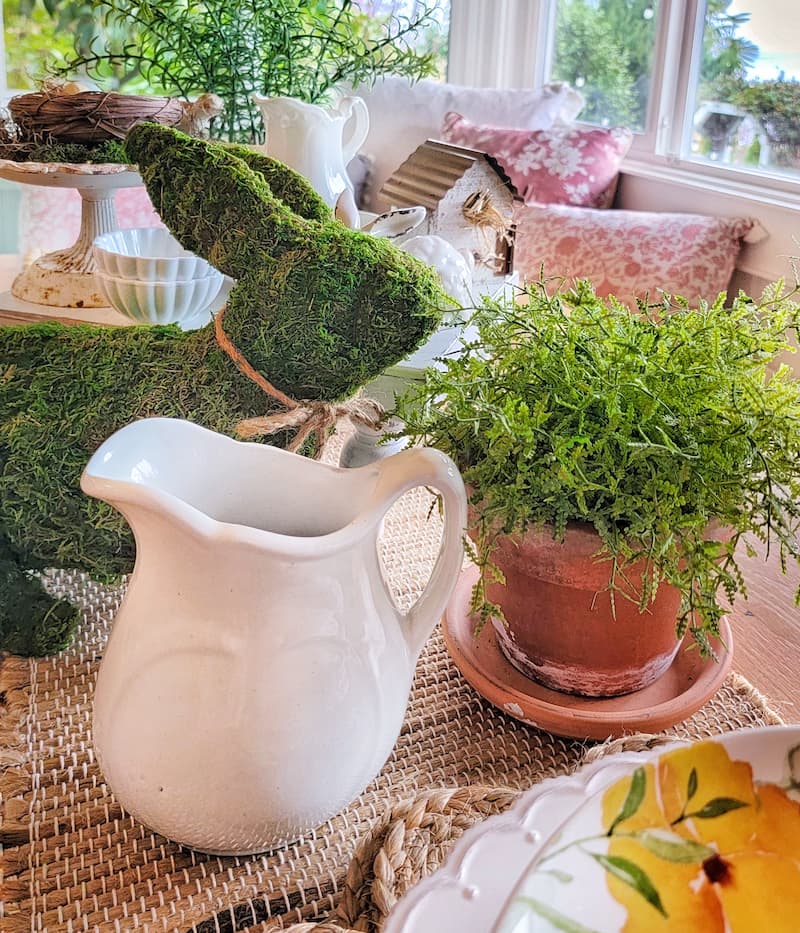 vintage terra cotta pot with plant and moss bunny