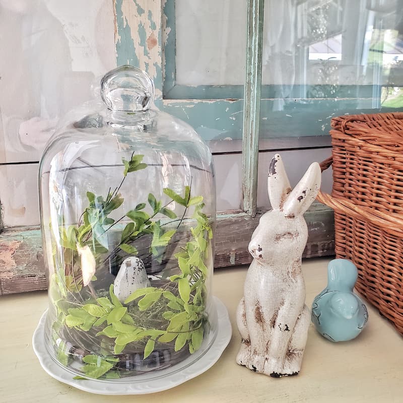 simple spring vignette with glass cloche, birds and bunny